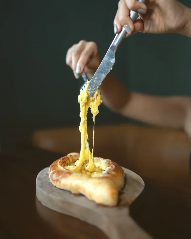 Melted cheese pulled from Adjarian khachapuri at Tarragon, Uluwatu