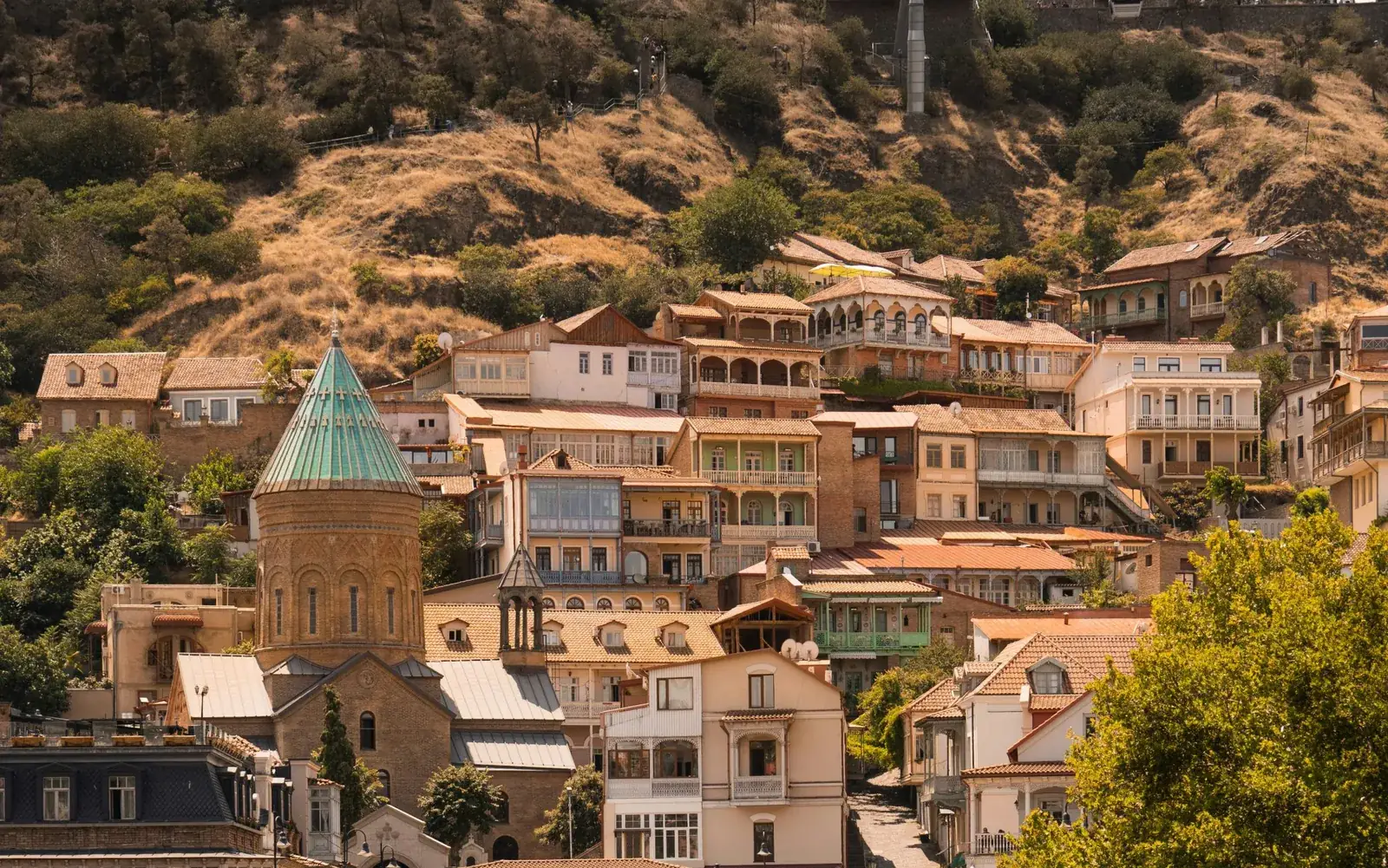 Old houses with carved wooden balconies on a hillside in Tbilisi, Georgia