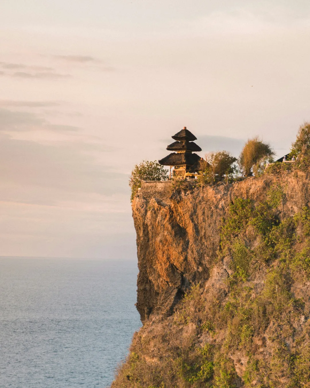 The tiered shrine of Uluwatu Temple on the cliff edge at golden hour, Bali